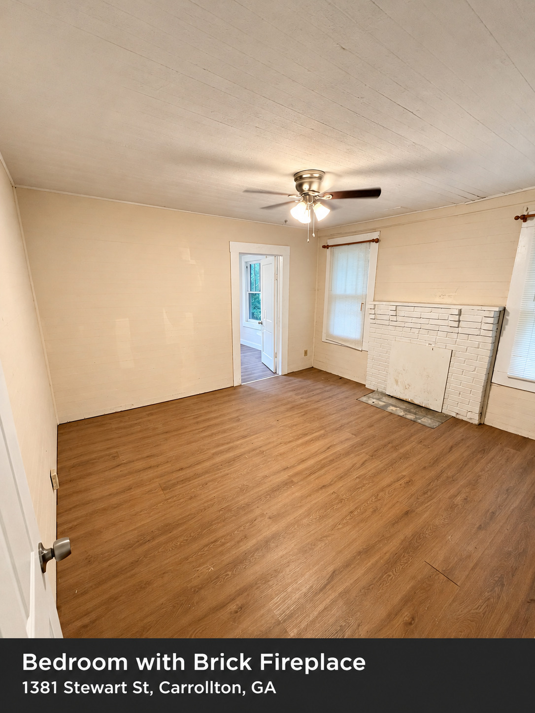 Bedroom with brick fireplace — 1381 Stewart St